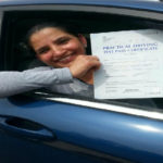 Balbir holding her certificate after passing her driving test with High Performance Driving School