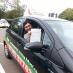 Hassan holding her certificate after passing her driving test with High Performance Driving School