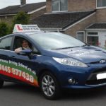 Nashwan holding his certificate after passing his driving test with High Performance Driving School