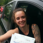 Rachel holding her certificate after passing her driving test with High Performance Driving School