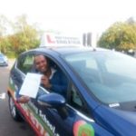 Simon holding her certificate after passing her driving test with High Performance Driving School